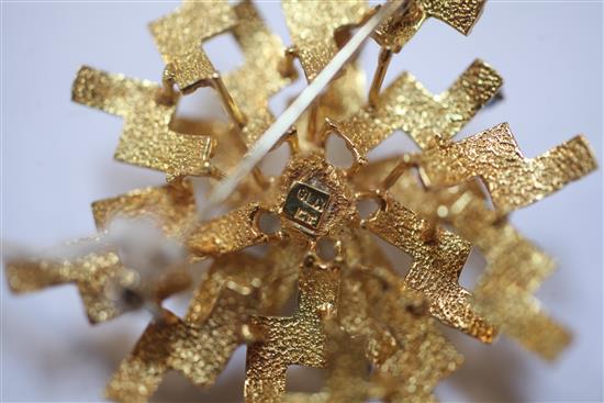 A 1970s? textured 18ct gold, diamond and sapphire set stylised starburst brooch, 43mm.